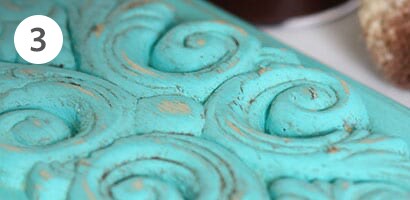 Closeup of the distressed painted board for the kitchen towel holder
