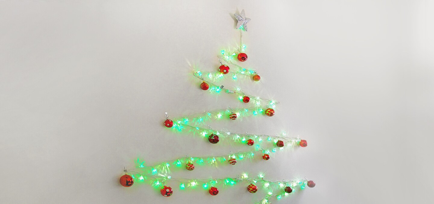 string light christmas tree on wall
