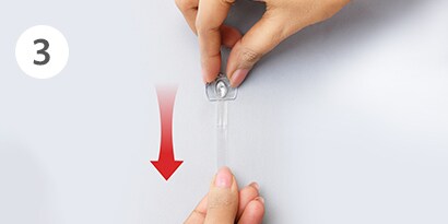 Stretch the strip slowly against the wall at least 12 inches to release
