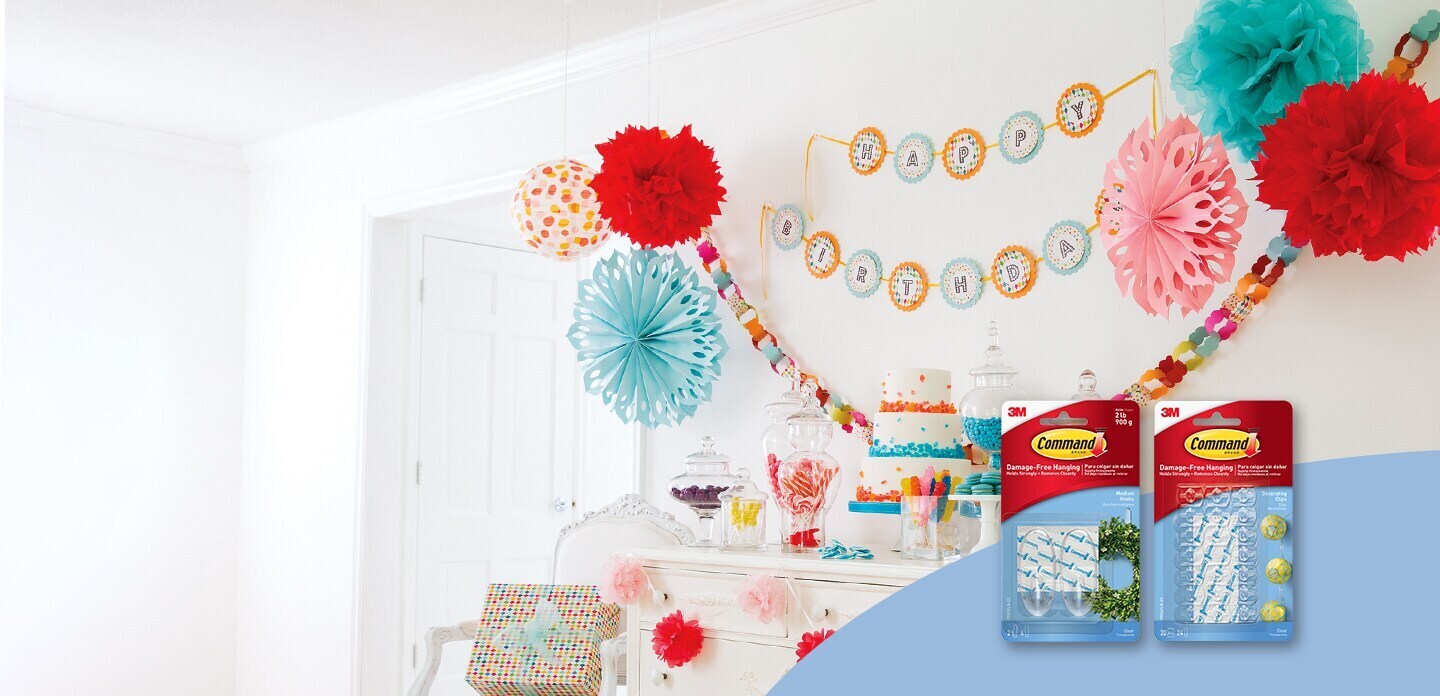 Party banners and garlands hung using adhesive hanging hooks from Command
