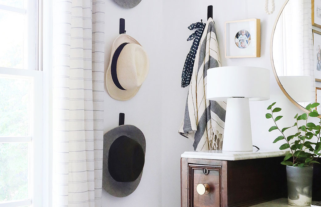 image of using command brand products to hang items like hats and clothing at home