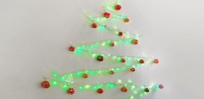 string light christmas tree on wall

