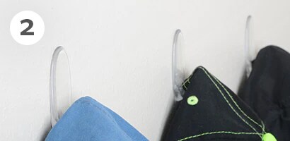 Hang caps on wall with Command™ Clear Medium Hooks
