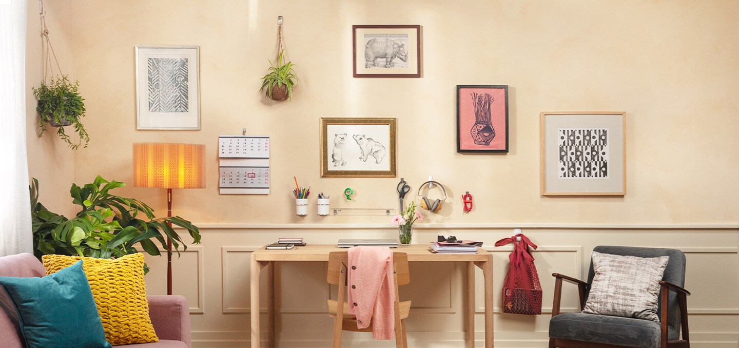 picture frames and artworks displayed using command wall hanging hooks
