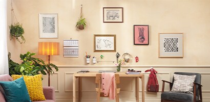 picture frames and artworks displayed using command wall hanging hooks
